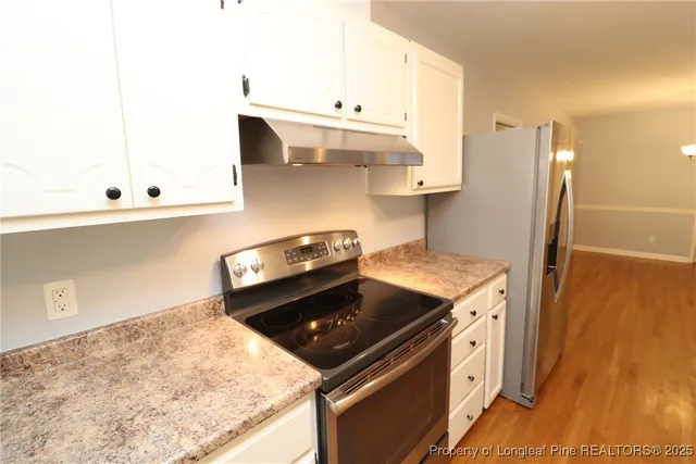 a kitchen with a stove and a microwave