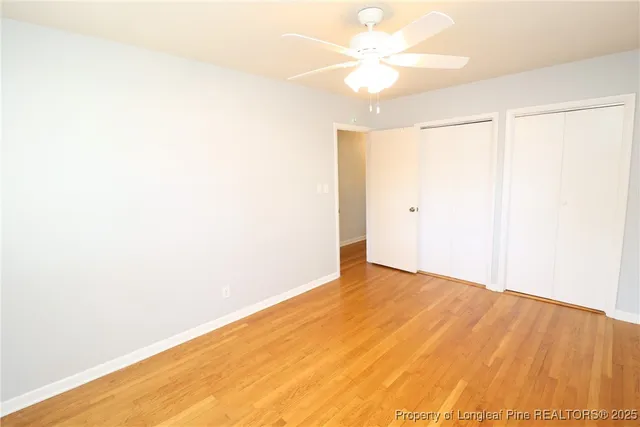 a view of a big room with closet and a ceiling fan