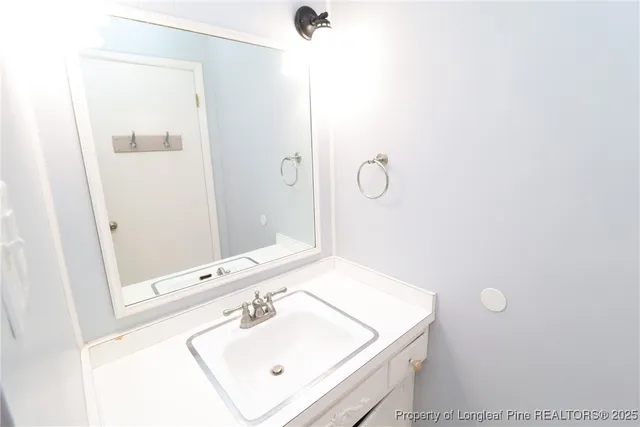 a bathroom with a sink a mirror and a shower