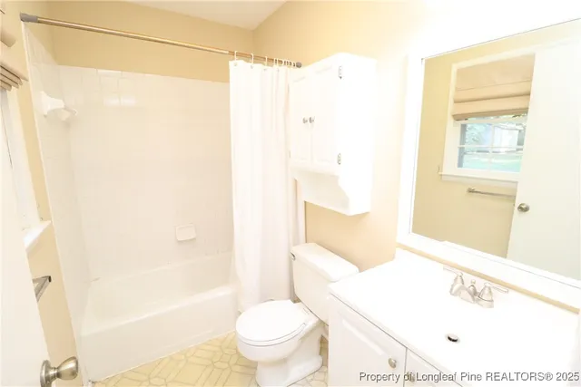 a bathroom with a shower a toilet and a sink