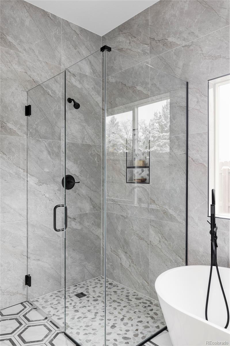 597 Rider Ridge Drive Longmont, CO 80504 - Photo 17 of 31 a bathroom with a bathtub and a shower