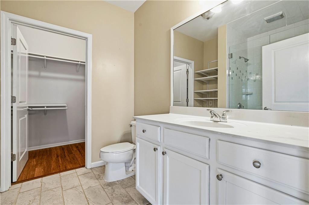 3040 Peachtree Road Northwest, Unit 1503 Atlanta, GA 30305 - Photo 16 of 38 a spacious bathroom with a granite countertop sink toilet and shower