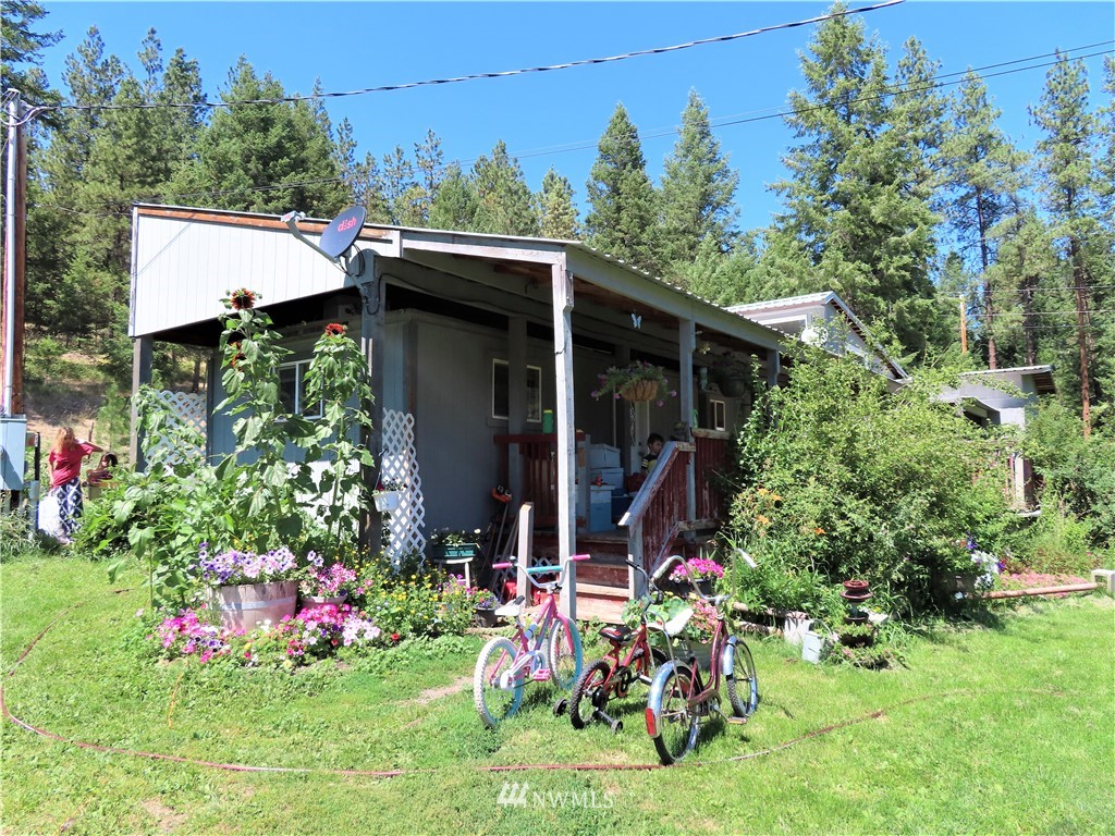 347 West Curlew Lake Road Republic, WA 99166 - Photo 2 of 26 a view of a chair and table in front of a house