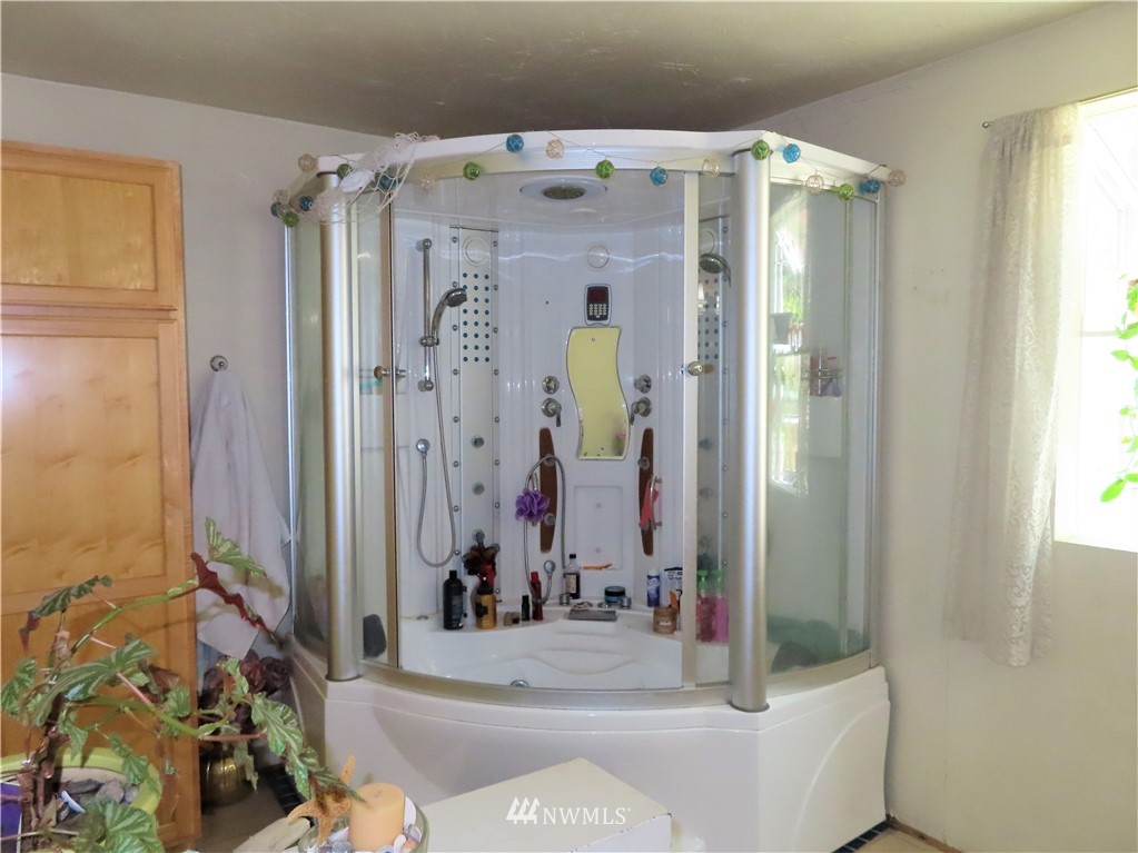 347 West Curlew Lake Road Republic, WA 99166 - Photo 12 of 26 a bathroom with a bathtub and shower