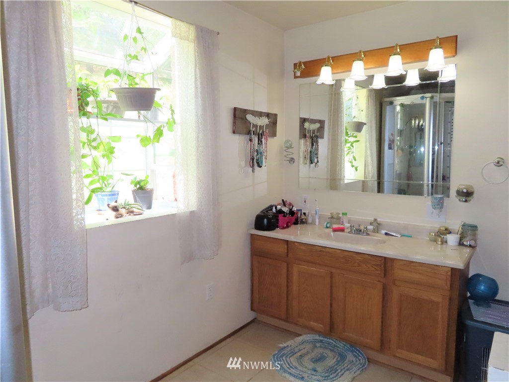 347 West Curlew Lake Road Republic, WA 99166 - Photo 13 of 26 a bathroom with a sink vanity and a mirror