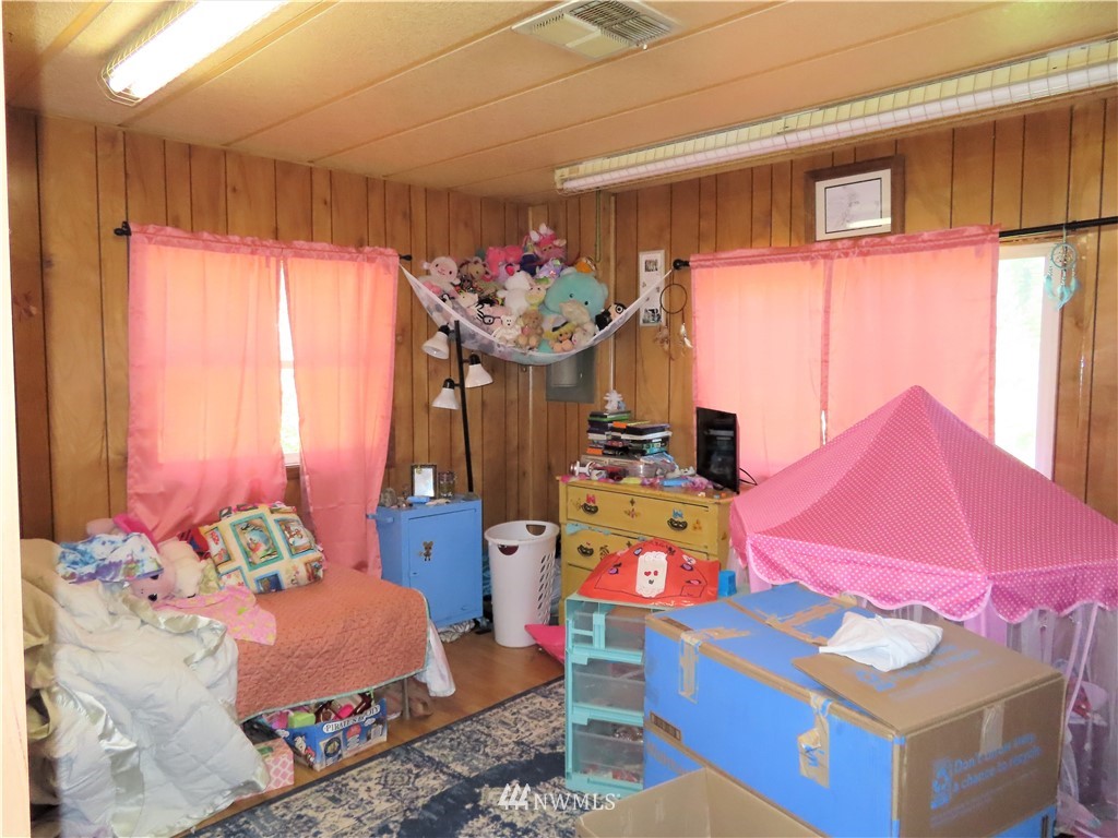 347 West Curlew Lake Road Republic, WA 99166 - Photo 14 of 26 a bedroom with furniture and a chandelier
