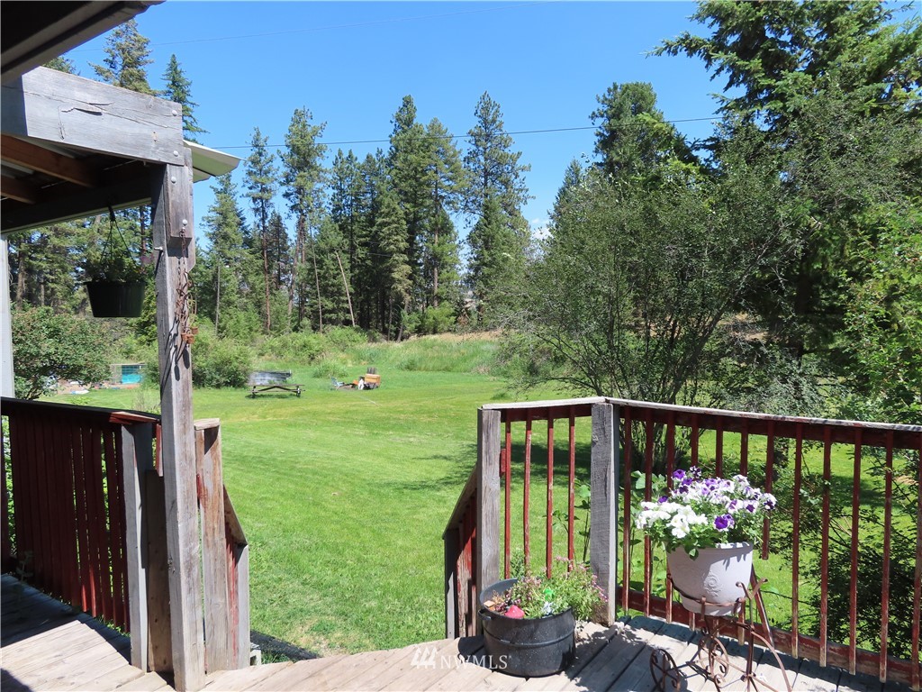 347 West Curlew Lake Road Republic, WA 99166 - Photo 19 of 26 a front view of a house with a yard table and chairs