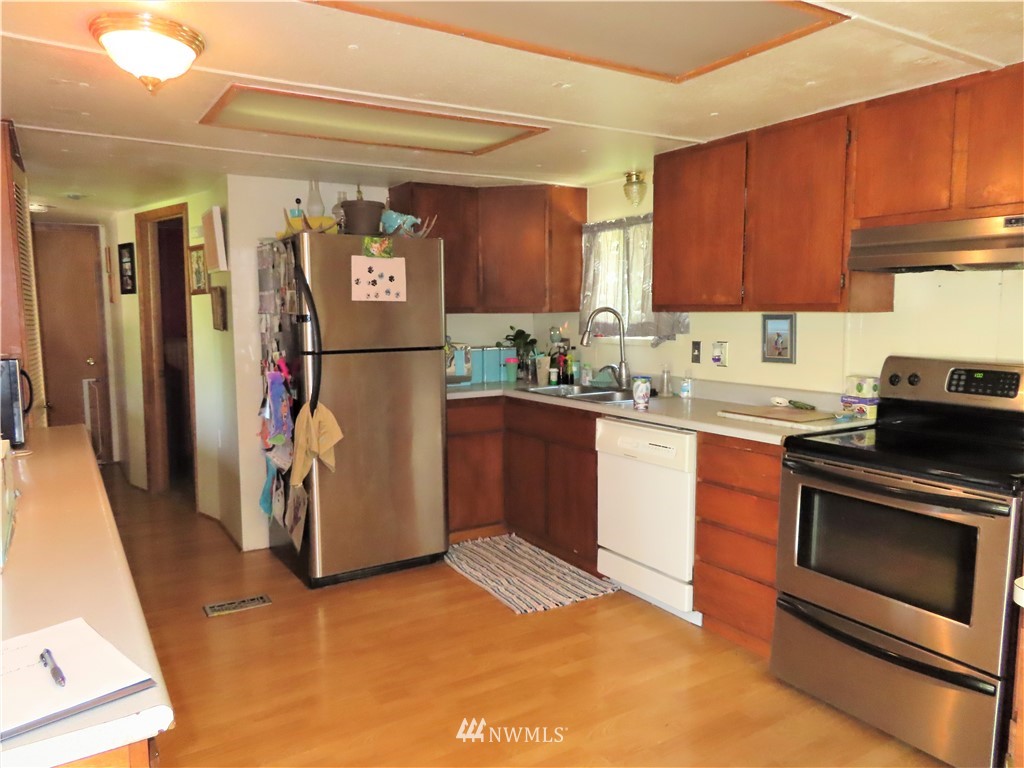 347 West Curlew Lake Road Republic, WA 99166 - Photo 3 of 26 a kitchen with a refrigerator sink and cabinets