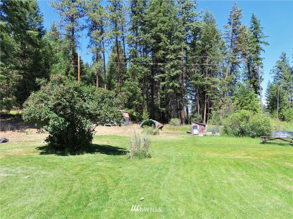 347 West Curlew Lake Road Republic, WA 99166 - Photo 21 of 26 a view of a garden with a bench