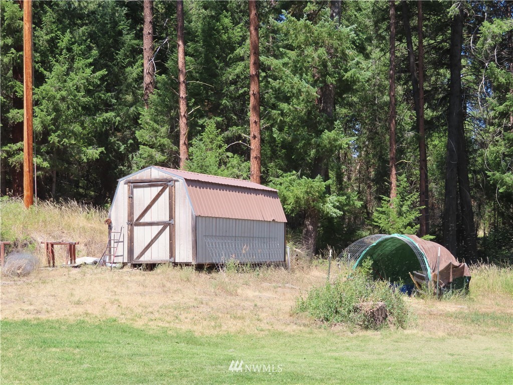 347 West Curlew Lake Road Republic, WA 99166 - Photo 22 of 26 a backyard of a house with yard and trampoline