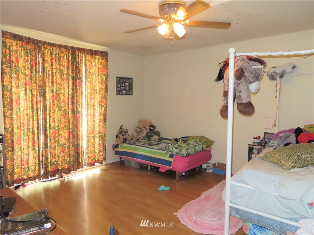 347 West Curlew Lake Road Republic, WA 99166 - Photo 10 of 26 a bedroom with a bed and a chandelier