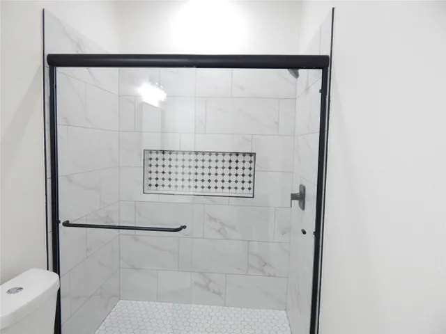 a bathroom with a shower and a toilet