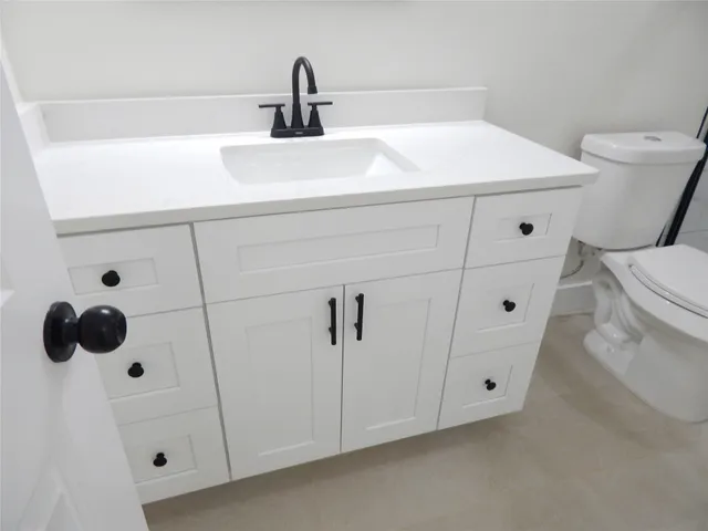 a bathroom with a sink and toilet