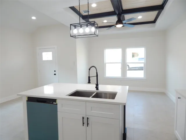 a bathroom with a sink a large mirror and vanity