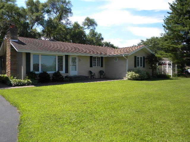 a front view of house with yard and green space