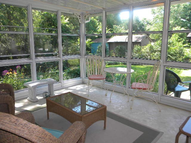 14049 South Bluff Road Rockton, IL 61072 - Photo 20 of 25 a living room with a large window and floor to ceiling window