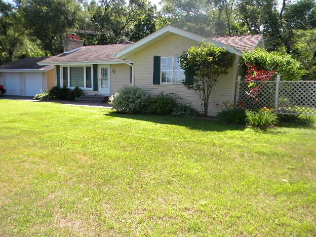 14049 South Bluff Road Rockton, IL 61072 - Photo 2 of 25 a front view of a house with garden