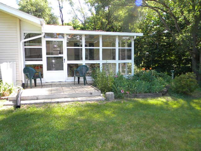 14049 South Bluff Road Rockton, IL 61072 - Photo 23 of 25 a view of house with backyard and a garden