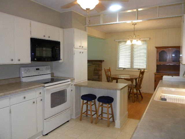 14049 South Bluff Road Rockton, IL 61072 - Photo 8 of 25 a kitchen with a sink stove and microwave