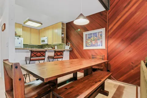 a dining room with furniture and wooden floor