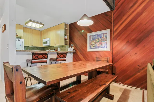 a dining room with furniture and wooden floor