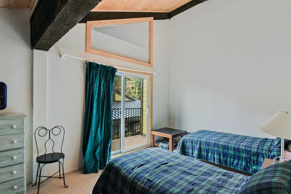 a bedroom with a bed a lamp and a window