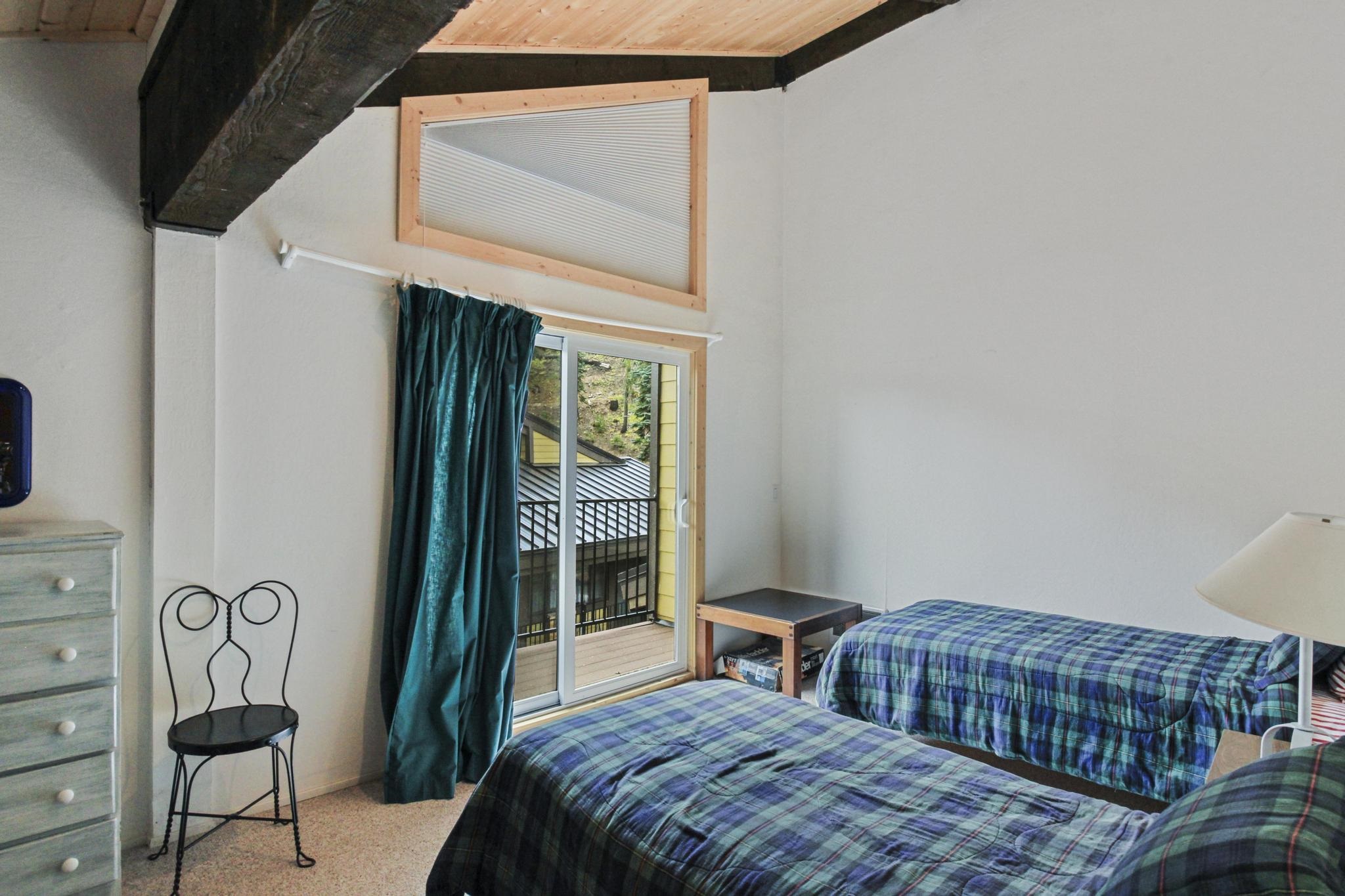 2090 Chalet Road, Unit 2 Alpine Meadows, CA 96146 - Photo 5 of 23 a bedroom with a bed a lamp and a window