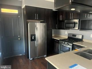 917 North Port Street Baltimore, MD 21205 - Photo 5 of 14 a kitchen with stainless steel appliances granite countertop a refrigerator and a stove top oven