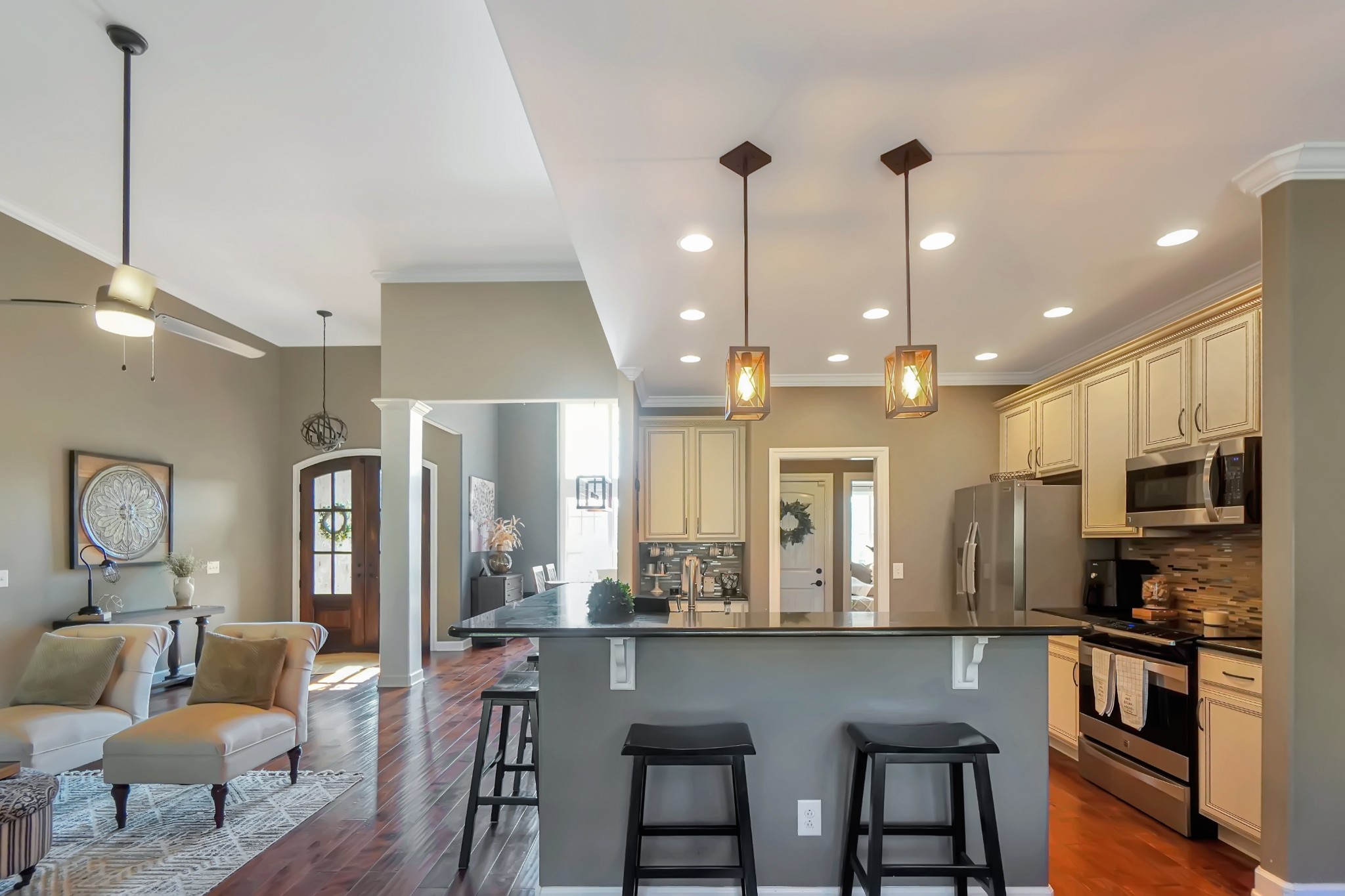 116 Cassandra Drive Cottontown, TN 37048 - Photo 28 of 53 a large kitchen with stainless steel appliances kitchen island granite countertop a dining table chairs and a refrigerator