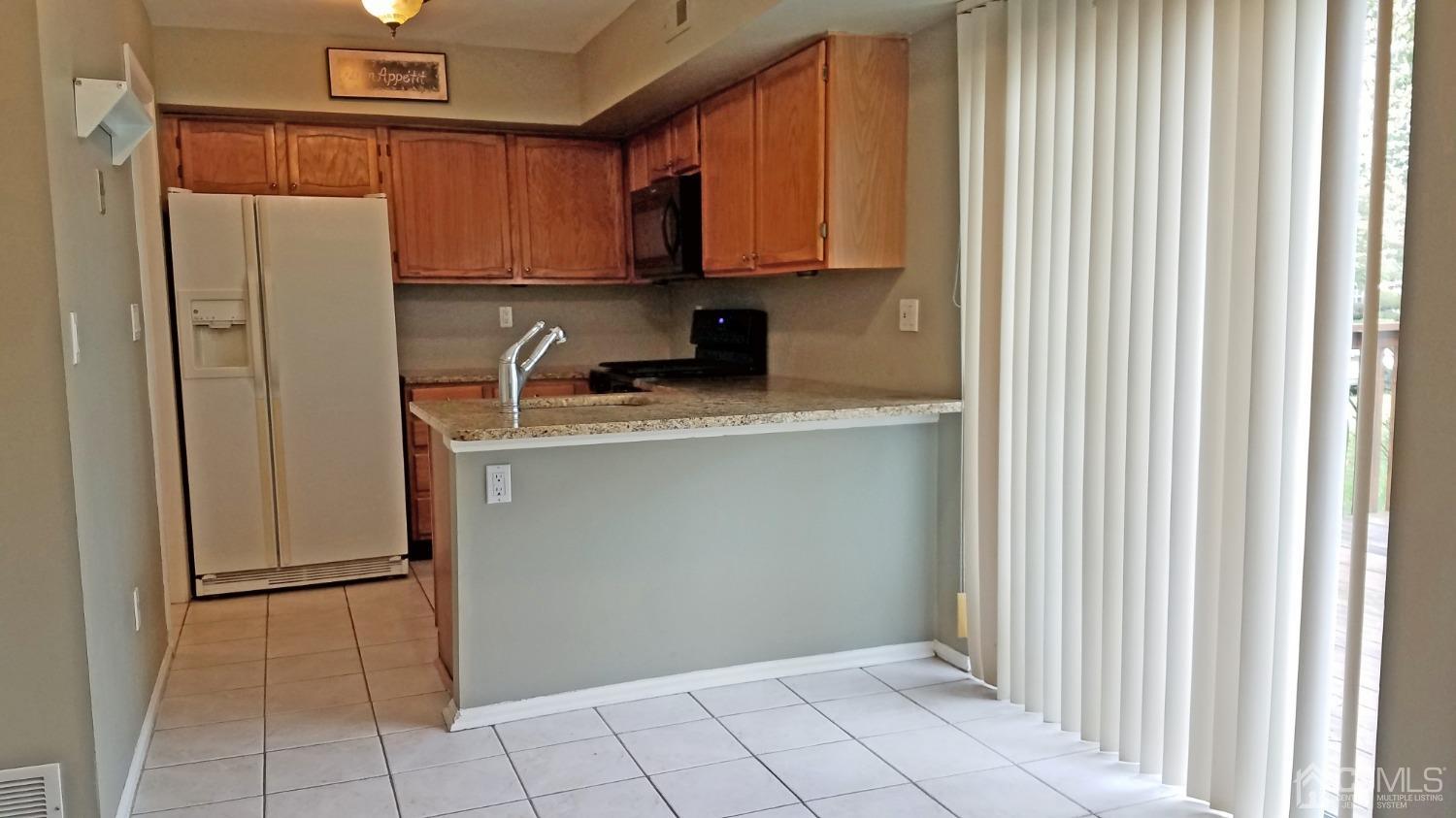 311 Classon Court Somerset, NJ 08873 - Photo 12 of 20 a kitchen with stainless steel appliances granite countertop a refrigerator and a sink