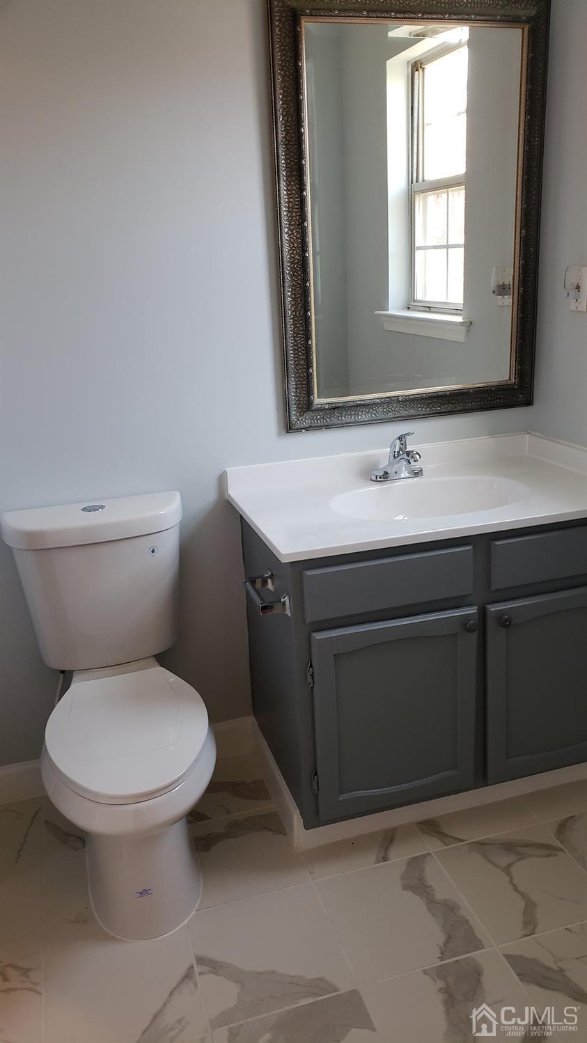 311 Classon Court Somerset, NJ 08873 - Photo 13 of 20 a bathroom with a toilet sink and mirror