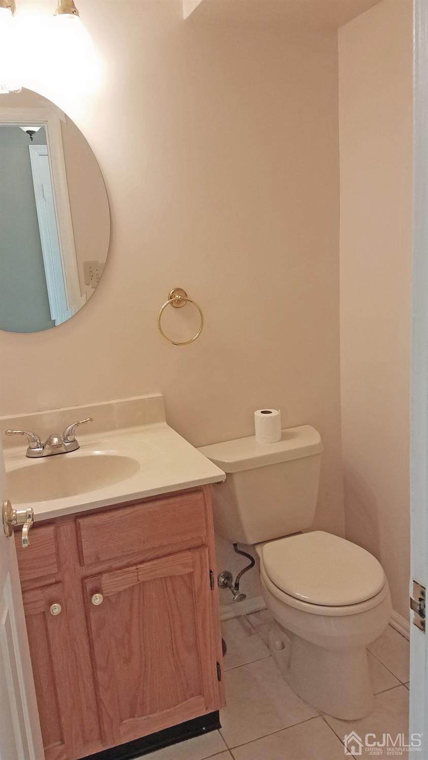 311 Classon Court Somerset, NJ 08873 - Photo 20 of 20 a bathroom with a granite countertop toilet sink and mirror