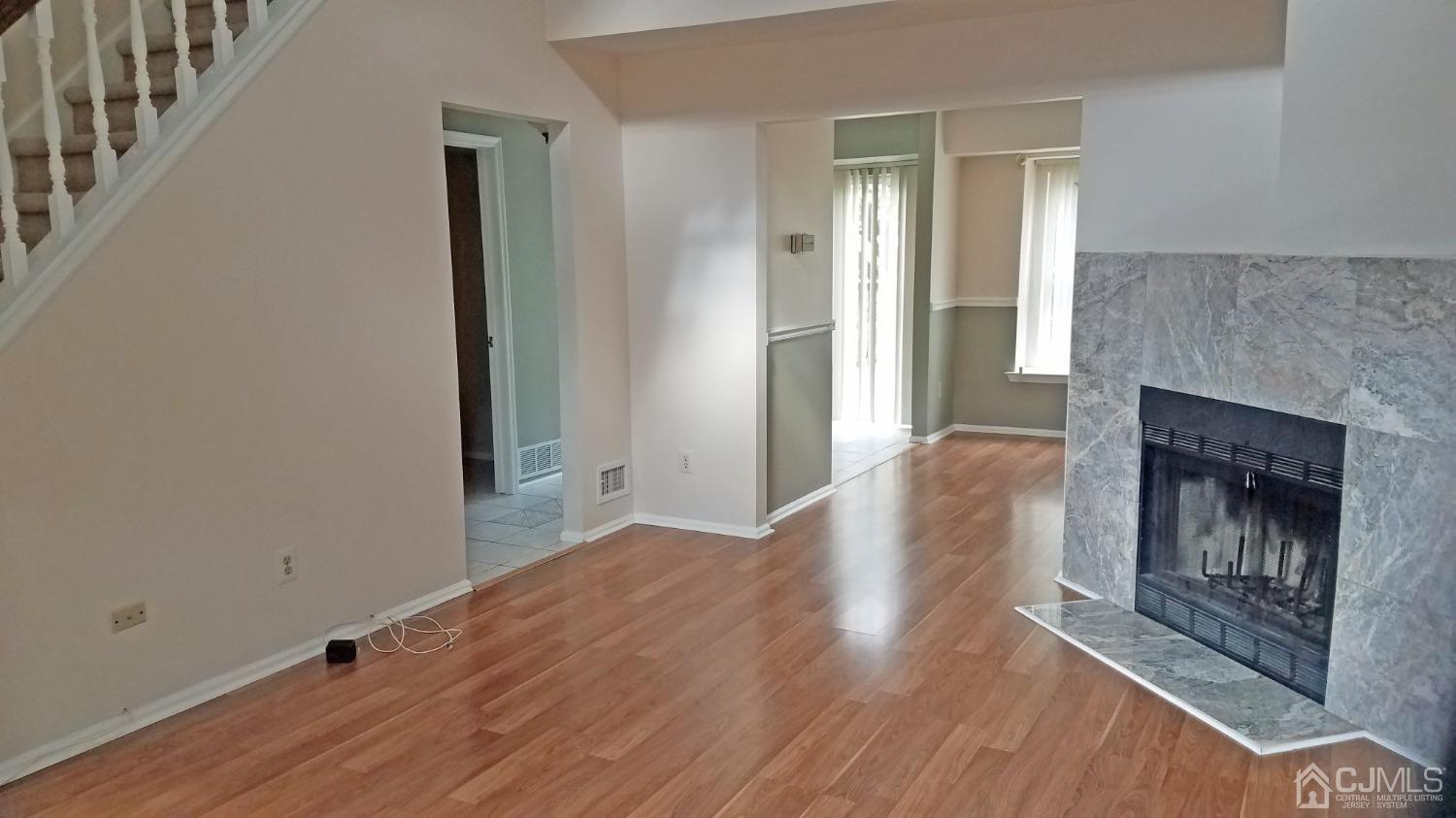 311 Classon Court Somerset, NJ 08873 - Photo 9 of 20 a view of a livingroom with wooden floor and a fireplace