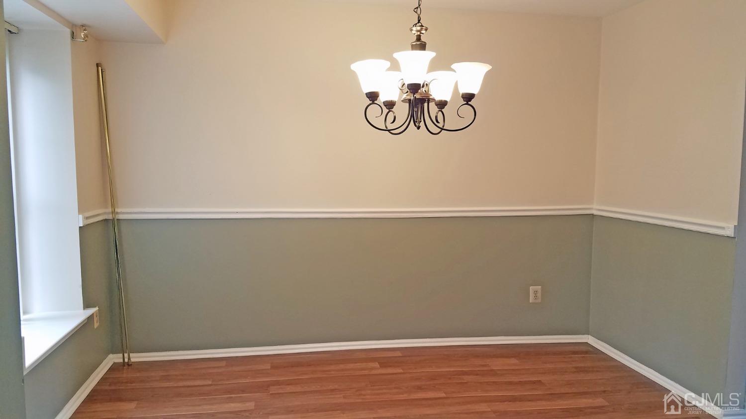 311 Classon Court Somerset, NJ 08873 - Photo 10 of 20 a view of a room with wooden floor and ceiling fan