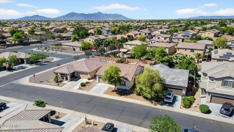 an aerial view of a houses with a city view
