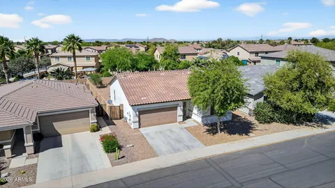 an aerial view of a house with garden space and street view