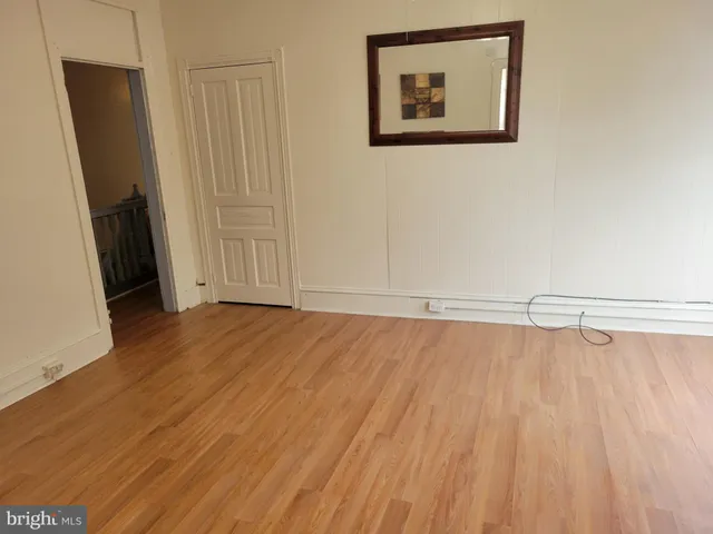 a view of a room with wooden floor and staircase