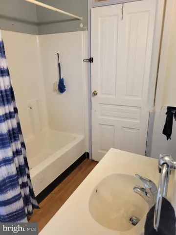 a bathroom with a tub and shower