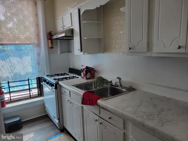 a kitchen with a sink and cabinets
