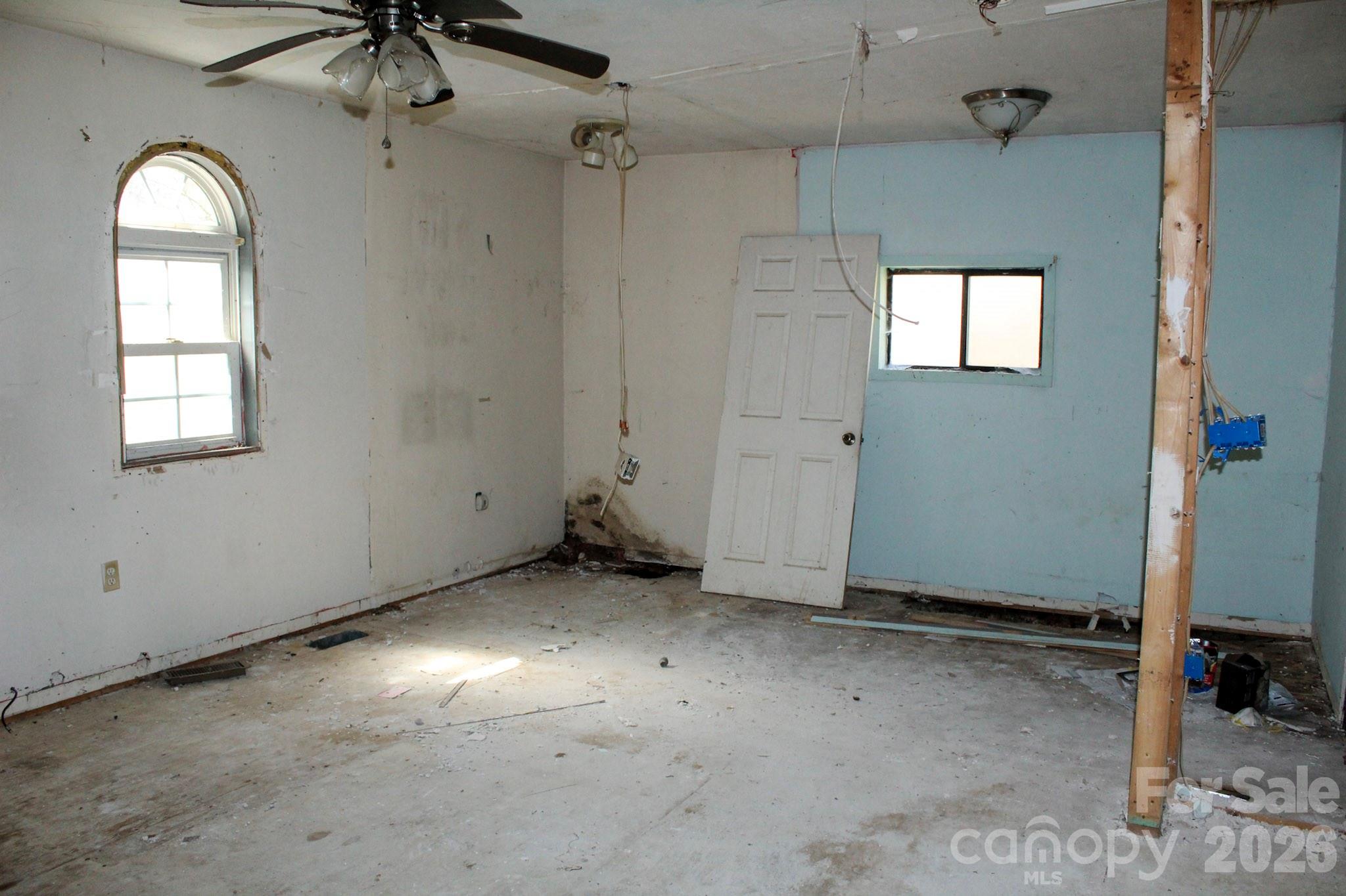 1293 Lake Logan Road Canton, NC 28716 - Photo 24 of 48 a view of a livingroom with a window and a chandelier fan
