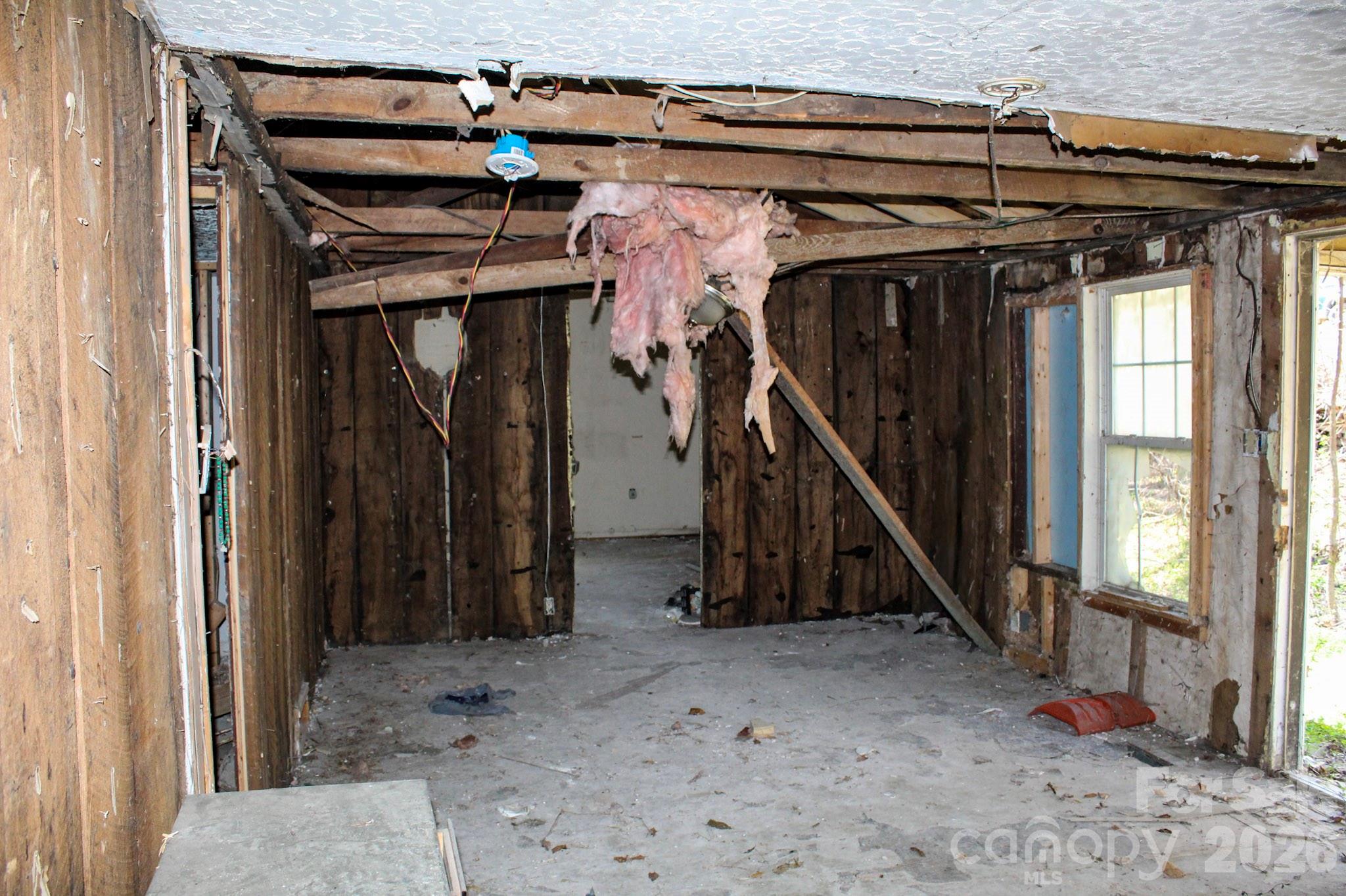 1293 Lake Logan Road Canton, NC 28716 - Photo 27 of 48 a view of a hallway with a small cabin and a couch