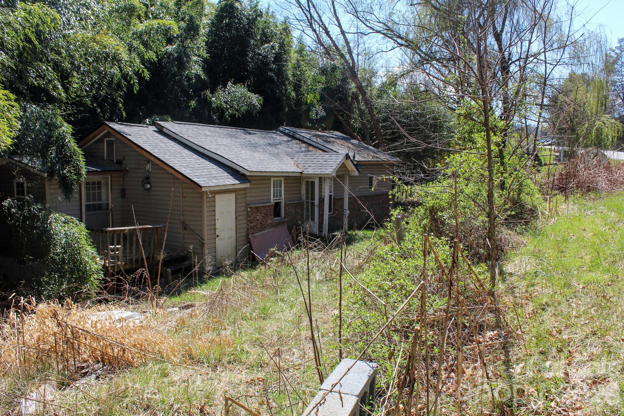 1293 Lake Logan Road Canton, NC 28716 - Photo 45 of 48 a backyard of a house with table and chairs