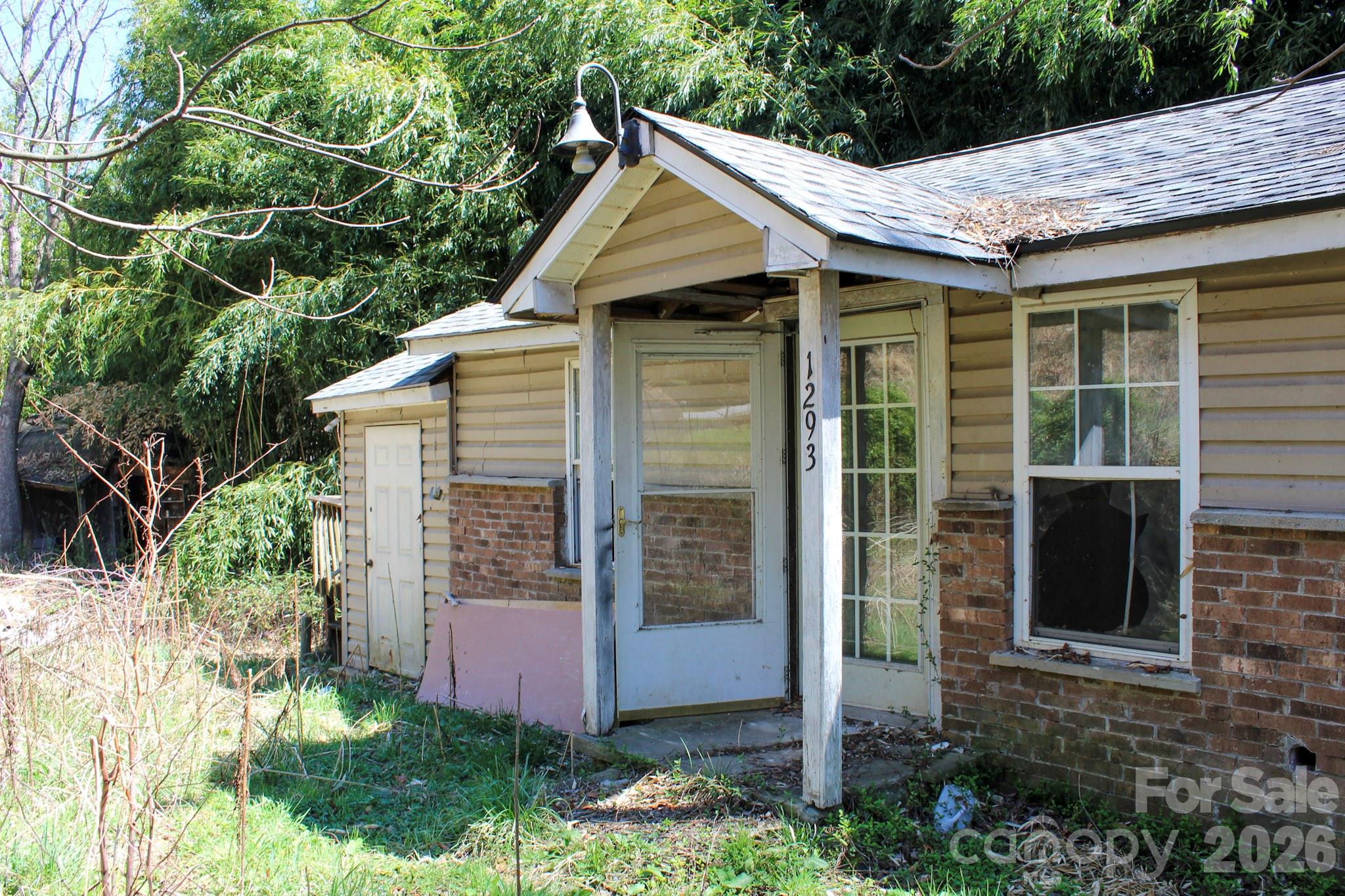 1293 Lake Logan Road Canton, NC 28716 - Photo 6 of 48 a front view of a house with garden