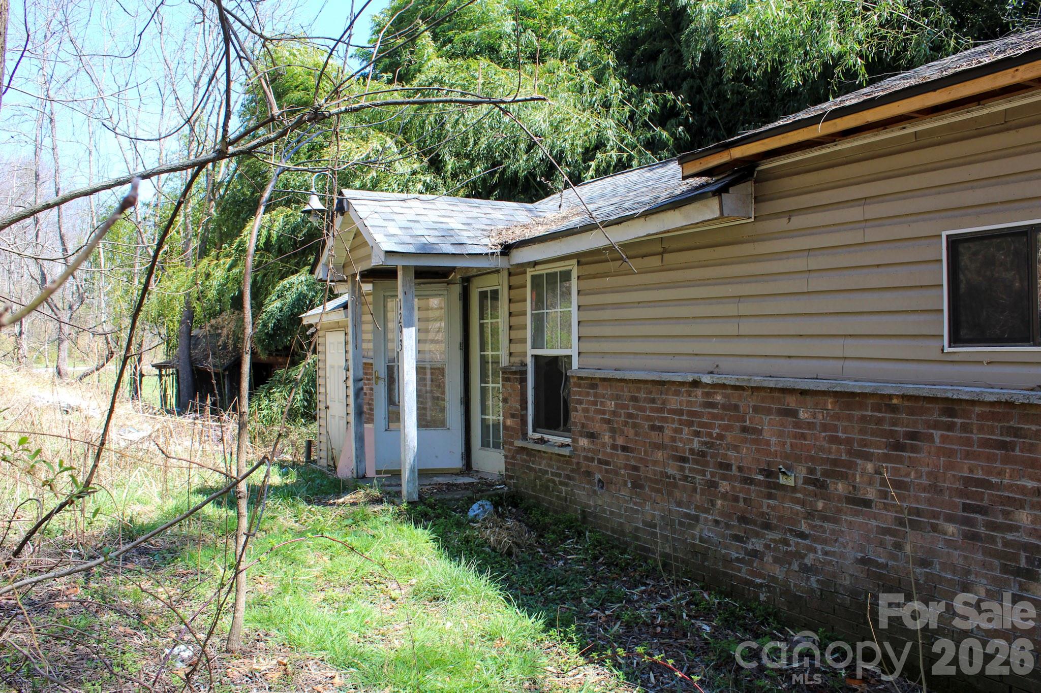 1293 Lake Logan Road Canton, NC 28716 - Photo 7 of 48 a view of house with backyard and garden