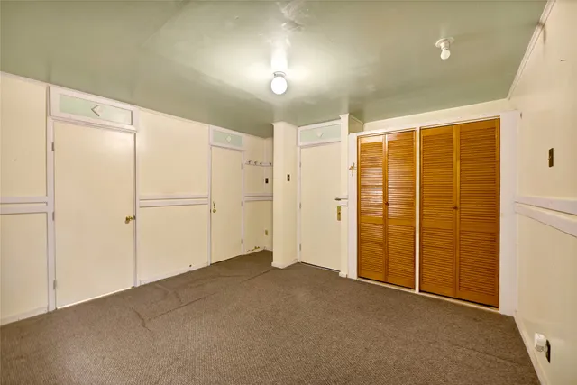 an empty room with closet area