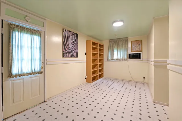 a view of a bedroom with wooden floor and windows
