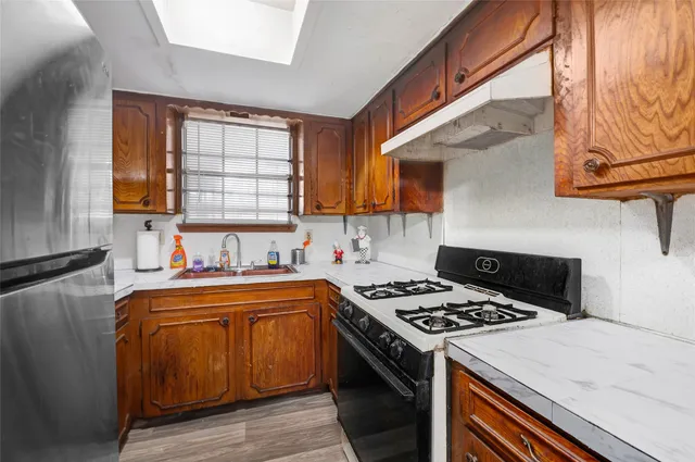 a kitchen that has a sink and a stove