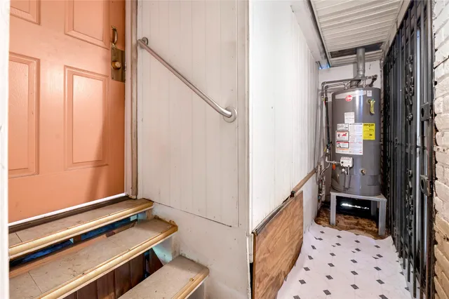 a hallway with wooden floor and white walls