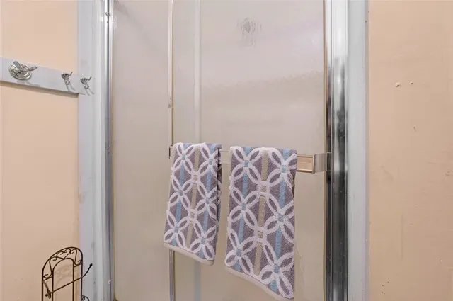 a bathroom with a shower curtain and a mirror