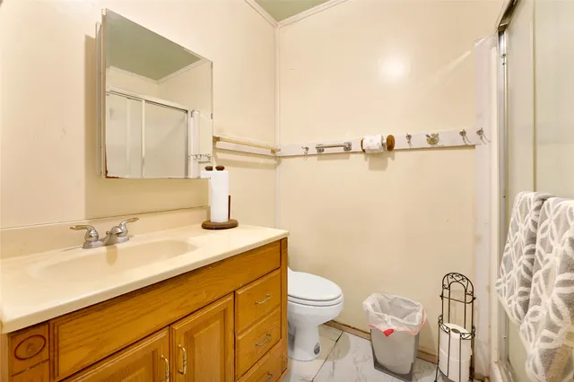 a bathroom with a sink a toilet and mirror
